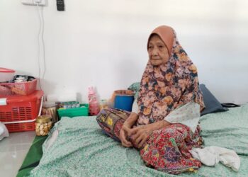 RAHMAH Shabudin yang dijaga cucunya masih mampu berpuasa di Felda Sungai Tekam di Jerantut, Pahang. – UTUSAN/HARIS FADILAH AHMAD