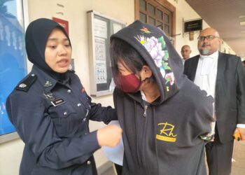 NGUYEN Thi Kim Oanh (memakai penutup kepala) ketika dibawa ke Mahkamah Majistret George Town, Pulau Pinang bagi menghadiri prosiding pendakwaan hari ini.