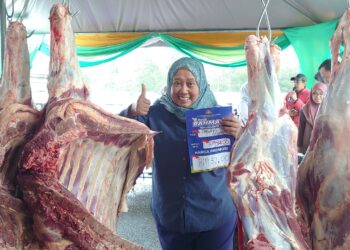 LILIS Saslinda Pornomo menunjukkan daging lembu segar yang dijual pada harga bawah pasaran semasa sesi walk about Program Jualan Rahmah Madani sempena Hari Raya Aidilfitri di Taman Nusa Damai, Pasir Gudang, Johor Bahru.