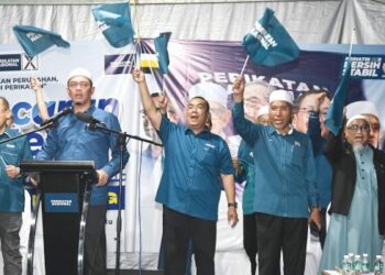 MUHAMMAD Sanusi Md. Nor (tengah) mengibar bendera PN pada pelancaran jentera parti untuk PRK Ayer Kuning di Tapah semalam. - UTUSAN/ZULFACHRI ZULKIFLI