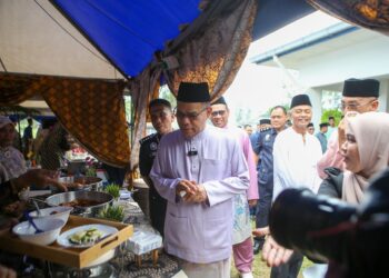 SAIFUDDIN Nasution Ismail beramah mesra dengan sebahagian tetamu dan anggota polis ketika hadir ke Majlis Sambutan Hari Raya Aidilfitri Warga Ibu Pejabat Polis (IPD) Kubang Pasu di Jitra hari ini. - UTUSAN/SHAHIR NOORDIN