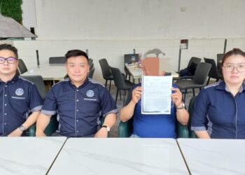 YEAP (dua dari kanan) menunjukkan salinan laporan polis yang dibuatnya sebelum ini ketika ditemui di Bukit Mertajam, Pulau Pinang baru-baru ini.