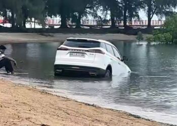 SEBUAH kereta SUV yang disewa tujuh pelajar warga Sudan tersangkut di pasir Pantai Cahaya Negeri, Port Dickson pagi tadi.-GAMBAR/IHSAN POLIS