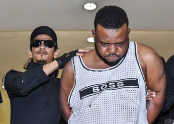 OKENYEHIKE Kelvin Obianke dibawa ke ke Mahkamah Majistret Kuala Lumpur semalam bagi didakwa atas pertuduhan menyebabkan kecederaan di bahagian telinga seorang anggota polis pada 25 April lalu.-UTUSAN/SYAKIR RADIN