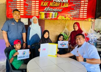 Ketua Pengarah Pendaftaran Negara (KPPN), Badrul Hisham Alias (kanan ) menyampaikan sijil kelahiran kepada kanak-kanak, Rose Azwa Safrina, di Kampung Pohon Barat, Kedai Menanti, Pasir Puteh, Kelantan semalam.-Jabatan Pendaftaran Negara Negeri Kelantan.
