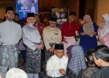 SYED Kamarulzaman (dua, kiri) bersama Menteri Hal Ehwal Agama Datuk Seri Mohd. Na'im Mokhtar, memberi duit raya kepada anak-anak asnaf, hari ini.