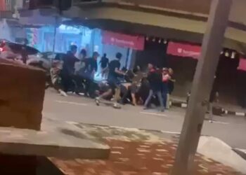 PERGADUHAN melibatkan sekumpulan lelaki di hadapan sebuah restoran di Jalan Meru Bestari dekat Meru Raya di Ipoh. - UTUSAN