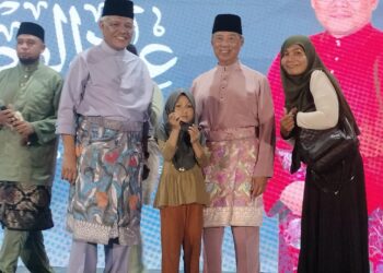 HAMZAH Zainudin (kiri) dan Muhyiddin Yassin bersama pemenang cabutan bertuah pada majlis  Rumah Terbuka Hari Raya Aidilfitri Bersatu di Selama semalam. - UTUSAN/WAT KAMAL ABAS