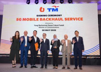 FAHMI Fadzil (tengah) bersama Naib Presiden Eksekutif TM Global, Khairul Liza Ibrahim (tiga dari kanan) dan Ketua Pegawai Teknologi U Mobile, Woon Ooi Yuen (tiga dari kiri) selepas majlis menandatangani perjanjian di antara kedua-dua syarikat di Petaling Jaya, semalam. - UTUSAN/SADDAM YUSOFF