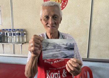 YEN Yoon Sun menunjukkan sekeping gambar lama bangunan Stesen Kereta Api Kuala Pilah, Negeri Sembilan yang disimpannya. - UTUSAN/NOR SHAFIQAH MOHD. GHAZALI