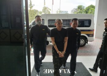 HAN Tun (tengah) ketika dibawa ke Mahkamah Sesyen Butterworth, Pulau Pinang atas pertuduhan cuba merasuah anggota polis.