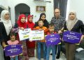 NORLIZA Abdul Rahim (dua dari kiri) menyerahkan manfaat takaful SSPN kepada Nur Aini Samiun, balu kepada anggota FRU yang maut dalam kemalangan Selasa lalu, Sarjan Mohd. Roslan Abd. Rahim di Tanjung Rambutan, Ipoh hari ini. - UTUSAN/MUHAMAD NAZREEN SYAH MUSTHAFA