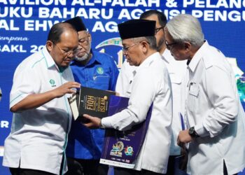 MOHD. Na'im Mokhtar melihat buku ketika merasmikan Pavilion Al-Falah dan melancarkan buku baharu sempena PBAKL 2025 di WTC Kuala Lumpur. - UTUSAN/FAUZI BAHARUDIN