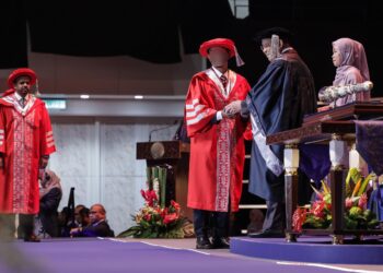 DR. MURAD (bukan nama sebenar) ketika menerima skrol ijazah Doktor Falsafah (PhD) dalam Pentadbiran Perniagaan pada Majlis Konvokesyen Open University Malaysia (OUM) ke-29 di Pusat Dagangan Dunia Kuala Lumpur hari ini. - UTUSAN/SYAKIR RADIN