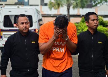 ANGGOTA polis (tengah) yang direman bagi membantu siasatan kes meminta dan menerima rasuah dibawa keluar dari Mahkamah Majistret Kuala Terengganu, hari ini.