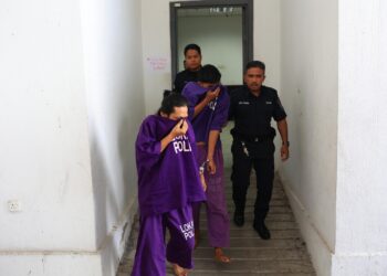 KEDUA-dua suspek semasa dibawa untuk mendapatkan perintah tahanan reman di Mahkamah Kota Bharu, Kelantan. - UTUSAN/KAMARUL BISMI KAMARUZAMAN 