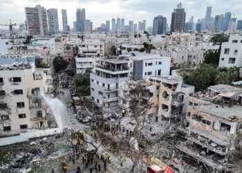 PENYELAMAT Israel meneruskan operasi menyelamat di runtuhan lokasi serangan peluru berpandu Iran di Bat Yam, pada 15 Jun lepas. – AFP