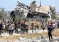 PIX 1 - RAKYAT Palestin membawa kotak bekalan bantuan daripada Yayasan Kemanusiaan Gaza (GHF) dari pusat pengagihan di tengah Gaza, minggu lalu.- AFP