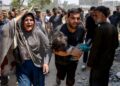 SEORANG lelaki mendukung kanak-kanak yang cedera dalam serangan Israel di kejiranan Saftawi, barat Jabalia, di Semenanjung Gaza.-AFP