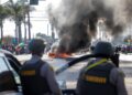 SEBUAH kereta terbakar ketika penguatkuasa undang-undang bertempur dengan penunjuk perasaan semasa protes berikutan operasi imigresen persekutuan, di kejiranan Compton di Los Angeles, California, kelmarin.- AFP