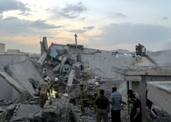 ORANG awam dan pasukan penyelamat berkumpul di atas bangunan yang terkena serangan Israel di Teheran, pada Jumaat lepas.- AFP