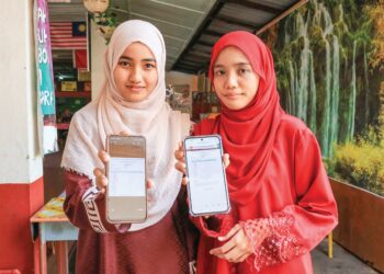 FATIN Nur Hanis Zulkifli (kanan) dan An-Nisa’ Mustapa menunjukkan keputusan STPM 2024 dengan keputusan PNGK 4.00 di SMK Tengku Panglima Raja, Pasir Mas, Kelantan. – UTUSAN/KAMARUL BISMI KAMARUZAMAN