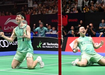 REAKSI Aaron-Wooi Yik selepas berjaya muncul juara Terbuka Singapura, kelmarin.-AFP