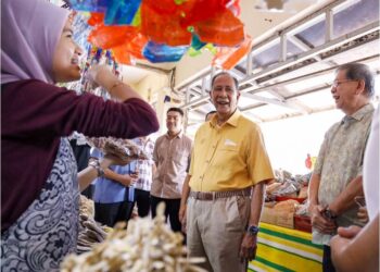 SULTAN Sallehuddin Sultan Badlishah menyantuni para peniaga ketika singgah mengadakan lawatan 
di Arked Tanjung Dawai, Kuala Muda.