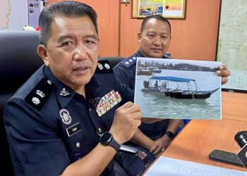 AZZAMUDIN Ahmad menunjukkan contoh bot yang karam semada sidang akhbar di IPD Besut, Terengganu. - UTUSAN/TOREK SULONG