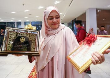 SHARIFAH Khasif Fadzillah Syed Badiuzzaman menunjukkan Anugerah Tokoh Maal Hijrah Negeri Perak  yang diterimanya pada Majlis Sambutan Maal Hijrah 1447H peringkat negeri di Ipoh semalam. - UTUSAN/MUHAMAD NAZREEN SYAH MUSTHAFA