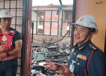 MOHD. Zaidi (kanan) meninjau lokasi kejadian kebakaran di SMK Dang Anum, Merlimau, Melaka awal pagi tadi.UTUSAN/AMRAN ALI