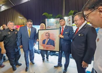 SHAMSUL Azri Abu Bakar (tiga dari kanan) menerima lukisan potret daripada wakil Majlis Perbandaran Hang Tuah Jaya (MPHTJ) pada Program Jelajah Taat Setia Madani Peringkat Negeri di Ayer Keroh, Melaka. - UTUSAN/AMRAN ALI