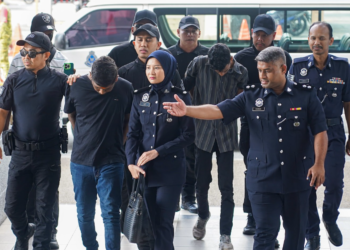 R. SANJJIIV (dua dari kiri) dibawa ke mahkamah semalam bagi pertuduhan memiliki senjata tiruan, mengugut dan mencederakan lima lelaki. - UTUSAN/ISKANDAR ISHAK