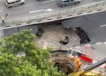 SEBUAH kenderaan terjatuh ke dalam lubang benam di kawasan jalan Tanjung Katong di Singapura.-AGENSI