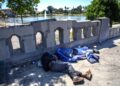 DUA lelaki gelandangan tidur di pejalan kaki di Taman MacArthur di Los Angeles, California. – AFP