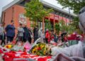 Orang ramai meninggalkan bunga, selendang dan baju di sebuah tugu peringatan yang terletak berhampiran dengan padang bola sepak Anfield untuk penyerang Portugis mereka Diogo Jota di Liverpool, di Liverpool, England pada Jumaat lalu. - AFP