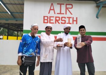 AZUHAN Fauzi (kanan) dan penduduk  menunjukkan perbezaan air bersih dari pam air berteknologi hijau dengan air boring di Pulau Teluk Rejuna Tumpat, Kelantan. – UTUSAN/ROHANA ISMAIL