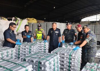 SHAMSUL Baharin Aman (tengah) melihat logam aluminium yang dirampas dalam serbuan di sebuah kilang di Kawasan Perindustrian Pengkalan 4 dekat Pusing, Batu Gajah hari ini.