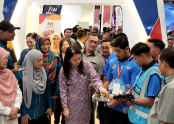 HANNAH Yeoh (tengah) melihat alat kawalan jauh yang digunakan mengawal 'battle robot' yang dipertandingkan di ASEAN Y-RoboC'25 dan Hari Kerjaya TVET ILKBS Zon Timur 2025 di Tunjong, Kota Bharu Kelantan hari ini. - UTUSAN/MUSTAQIM MOHAMED