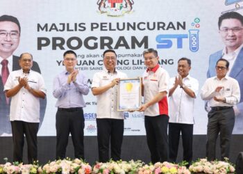 KETUA Pegawai Eksekutif Malaysia Book of Records, Christopher Wong (tiga kanan) menyerahkan sijil anugerah kepada Chang Lih Kang (tengah) pada majlis Peluncuran Program STI 1003 Sekolah Menengah Kebangsaan Tiara Permai di sini hari ini.  - UTUSAN/FARIZ RUSADIO