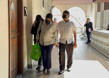 TERTUDUH, M.Santhiea (berjaket hitam) bersama ibu bapanya ketika tiba di Kompleks Mahkamah Pulau Pinang, di George Town, hari ini.