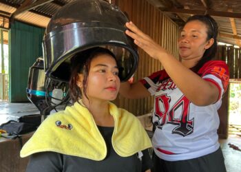 MELEY Alug menggunakan mesin stim yang diberikan Jakoa untuk
melakukan rawatan rambut pelanggan di rumahnya di Kampung Dusun
Raja, RPS Kuala Betis, Kelantan. – UTUSAN/AIMUNI TUAN LAH