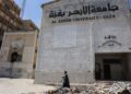 GRADUAN Palestin membawa bunga sambil berjalan melewati runtuhan bangunan Universiti Al-Azhar di Gaza City. – AFP