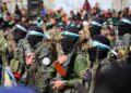 PENDUDUK Palestin dan pejuang Hamas berkumpul sebelum pembebasan tiga tebusan Israel di Nuseirat, tengah Gaza, pada 22 Februari lalu.- AFP