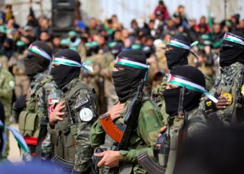 PENDUDUK Palestin dan pejuang Hamas berkumpul sebelum pembebasan tiga tebusan Israel di Nuseirat, tengah Gaza, pada 22 Februari lalu.- AFP