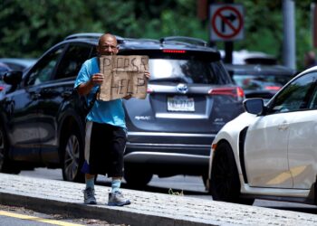 SEORANG gelandangan meminta bantuan ketika berjalan di sektar Rock Creek Parkway di Washington.-AFP