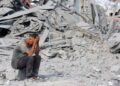 SEORANG lelaki Palestin duduk di sebelah runtuhan bangunan selepas serangan Israel di Pusat Kesihatan Sheikh Radwan yang dikendalikan UNRWA di utara Bandar Gaza, pada Khamis lalu.- AFP