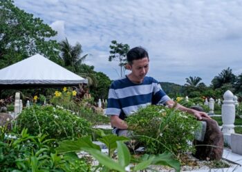 Amirul Nafis Amiruddin menziarah pusara arwah isterinya di Tanah Perkuburan Islam Tadik Puteri, Rawang. - UTUSAN/M. FIRDAUS M. JOHARI