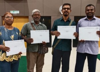M. Nalla Kumar (dari kanan), R. Palanisamy, R. Bhaskar dan R. Sarojini menunjukkan dokumen berkaitan pemilikan tanah ketika ditemui pada Majlis Penyerahan Surat Kelulusan PTK dan Notis 5A di Alor Gajah, Melaka. - UTUSAN/MUHAMMAD SHAHIZAM TAZALI