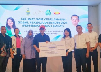 STEVEN SIM Chee Keong menyerahkan tajaan caruman Skim Keselamatan Sosial Pekerjaan Sendiri (SKSPS) kepada Lim Siew Khim di George Town, Pulau Pinang, hari ini.